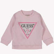 女の女の子のセーターが淡いピンクを推測します